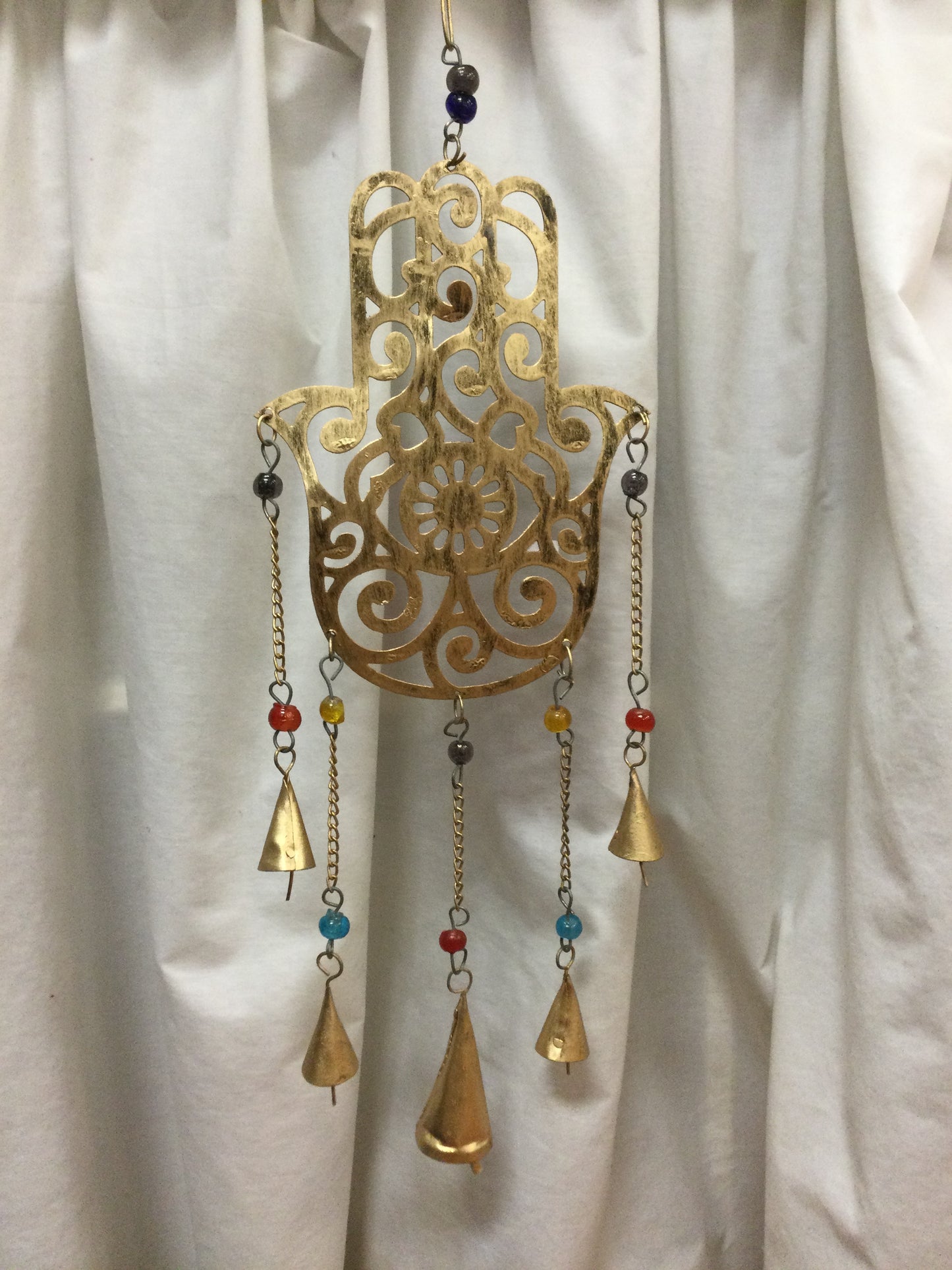Brass Bell Chimes on Ornate Hand