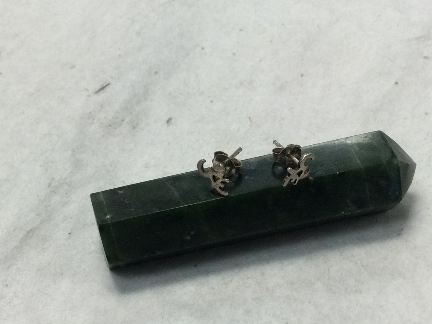 various silver studs (om, feathers, Buddha, etc.)