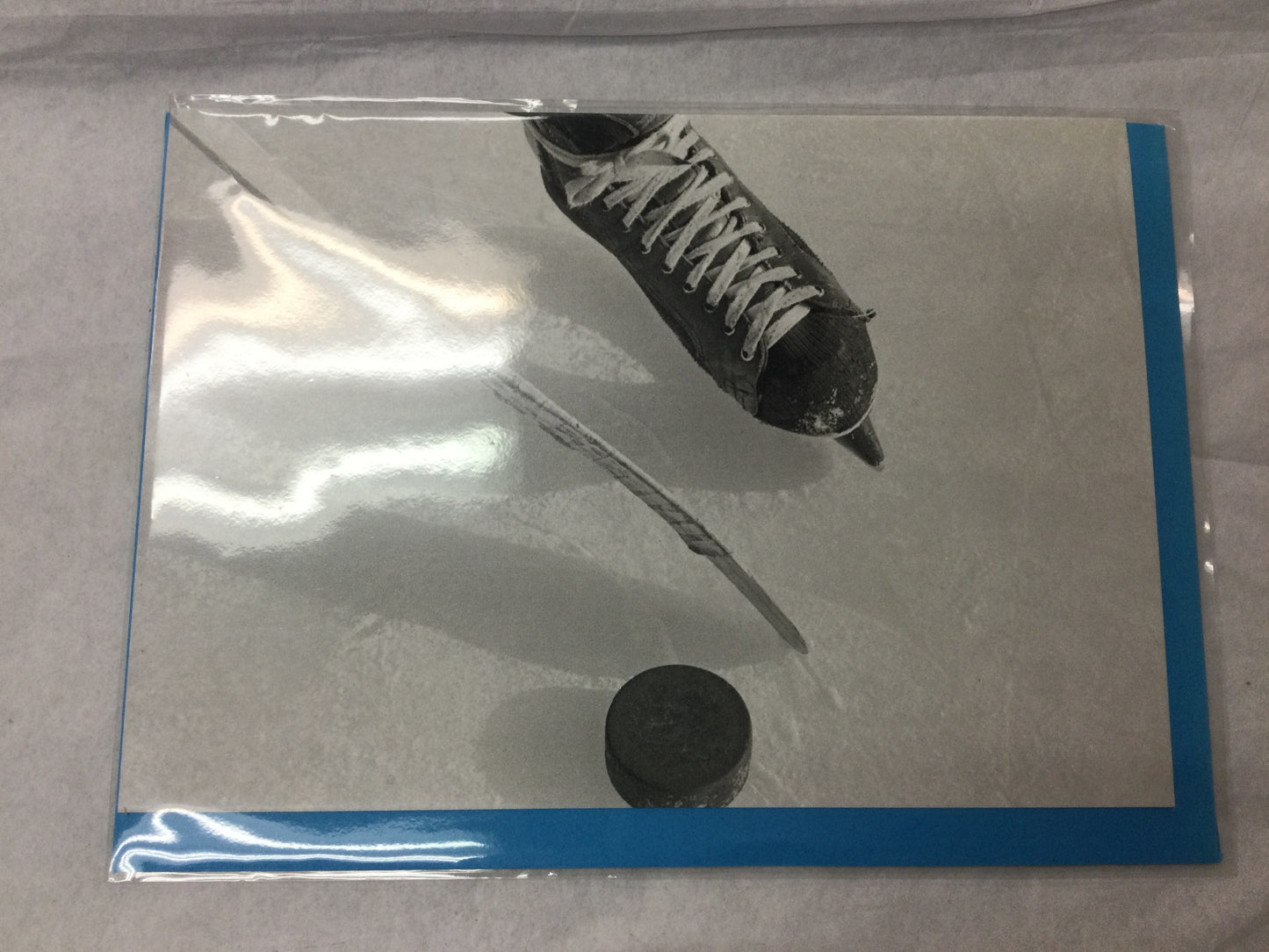 card, hockey skate and stick/puck