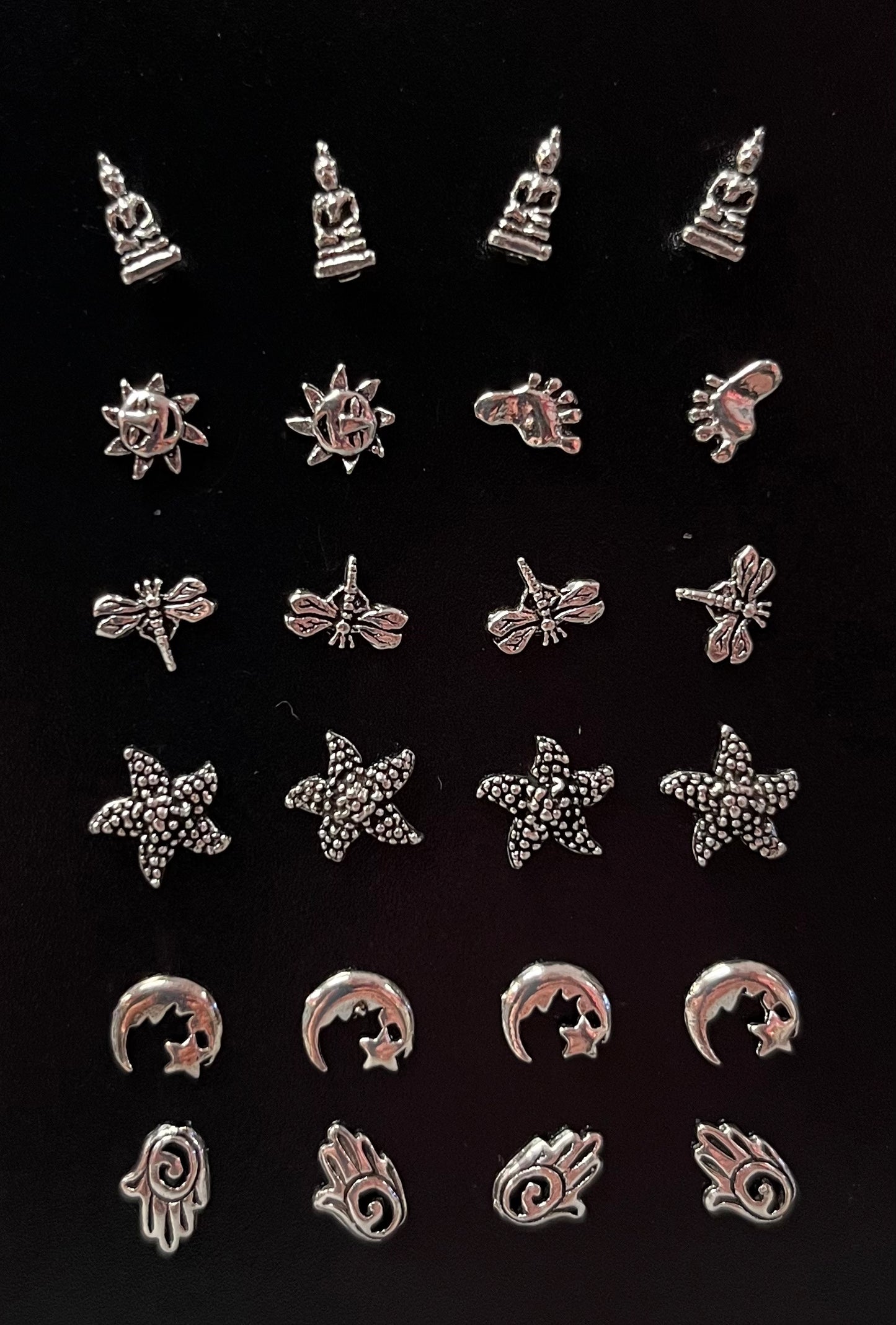 various silver studs (om, feathers, Buddha, etc.)