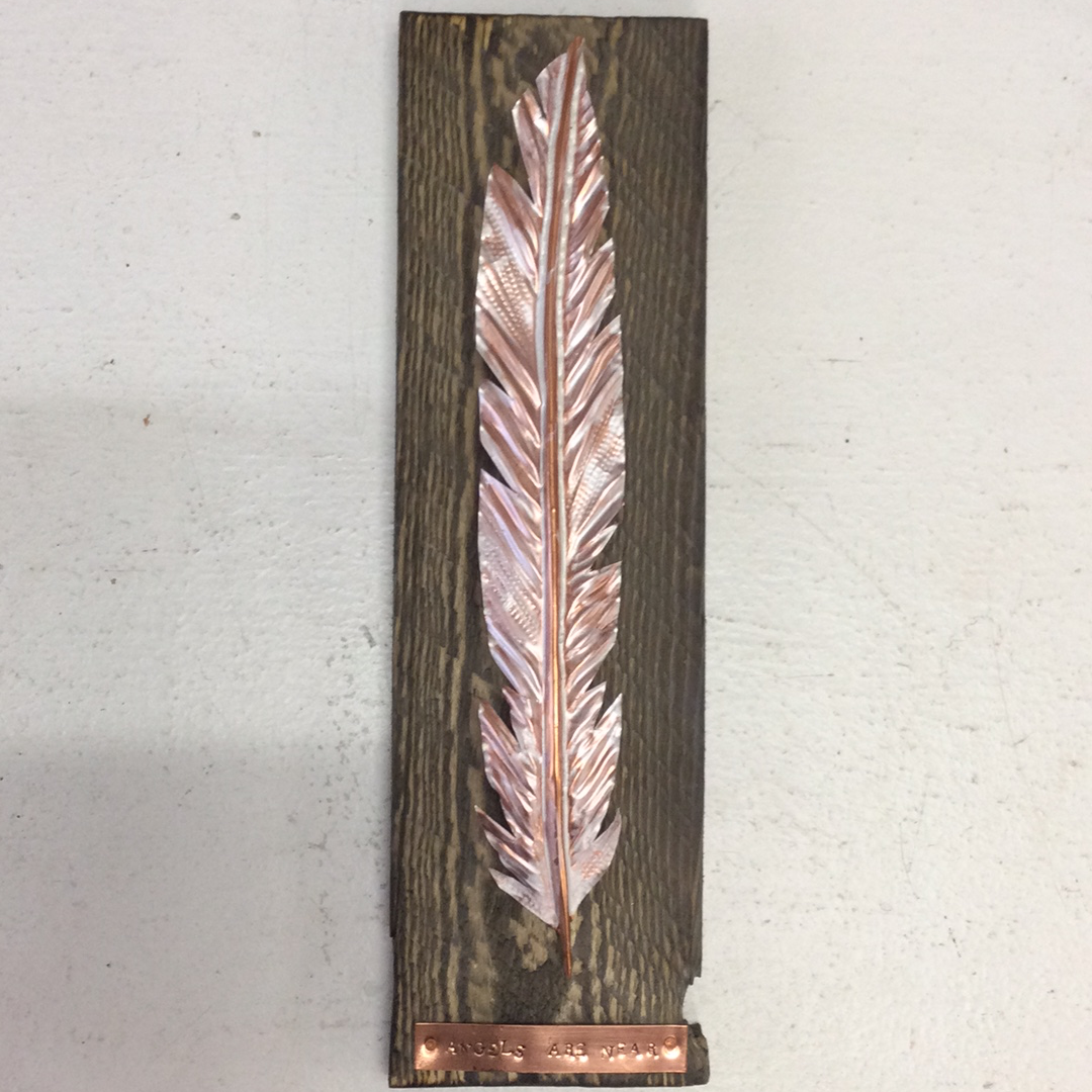 Copper Angel Feather on wood