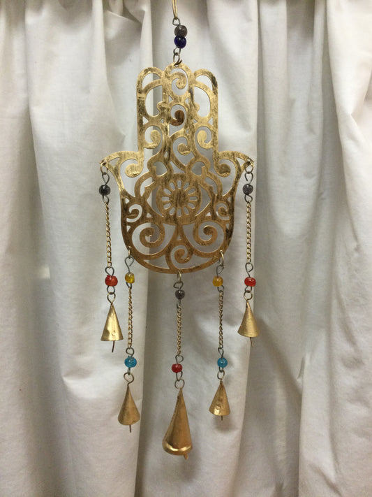 Brass Bell Chimes on Ornate Hand
