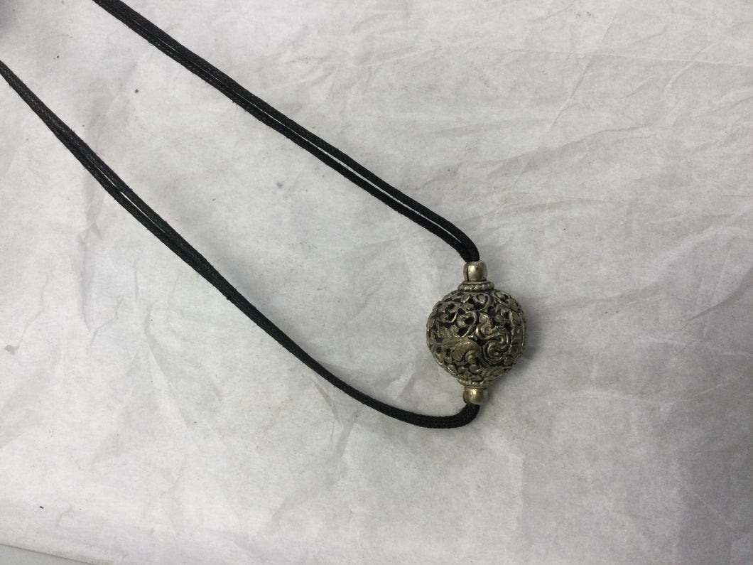 black cord necklace with silver decorative ball pendant